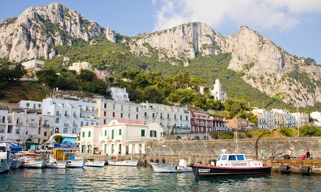 View of harbour, buildings and mountains from the sea, Marina Grande, Capri, Italy.