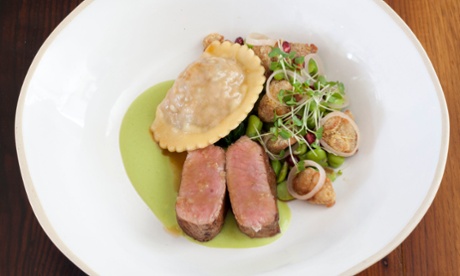 Two slices of lamb loin next to a raviolo made with lamb's liver and crisped sweetbreads