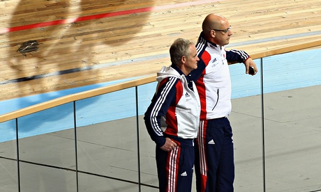 Dave Brailsford and Steve Peters in tracksuits standing in a velodrome 