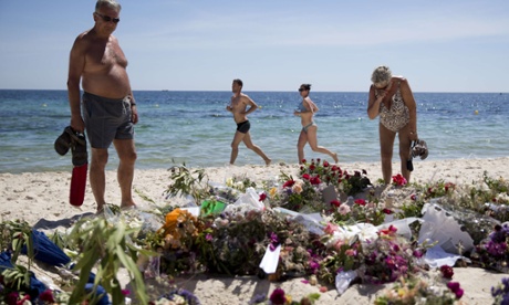 Floral tributes have been placed where the attack started on the beach.