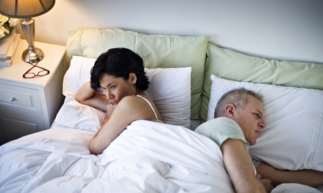 couple in bed facing away from each other