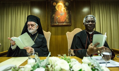 Cardinal Turkson and Orthodox metropolitan of Pergamon Joannis Zizioulas present Pope Francis's encyclical letter.