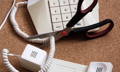 scissors cutting through telephone cord