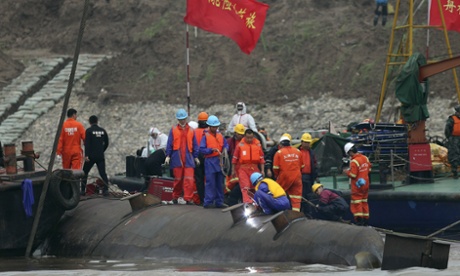 Rescue workers on the hull of the capsized Eastern Star.