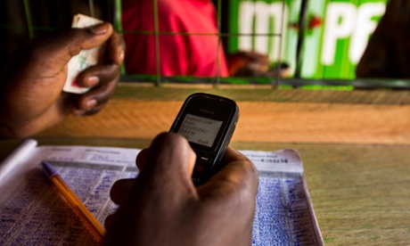 An employee uses a Nokia 1200 mobile phone inside an M-Pesa store in Nairobi, Kenya.