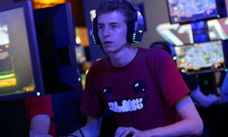 A computer gamer sits in front of a screen at the Gamescom fair in Cologne, Germany.