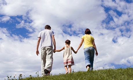 Parents with daughter, hand in hand.