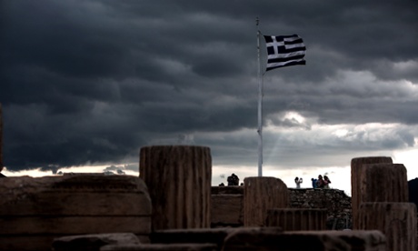 A Greek flag waves in the breeze at Acropolis hill, in Athens on 5 June.