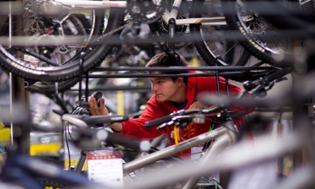 Customer inspects bikes at a Halfords store in Stratford-upon-Avon.