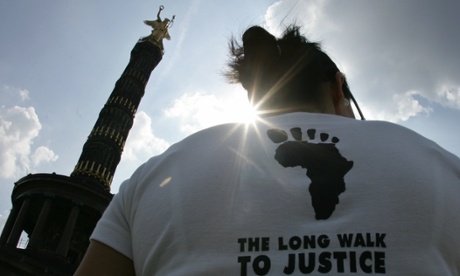 An activist taking part in the ‘The long walk to justice’ rallies in front of Berlin’s victory column on 3 July 2005. The walk from Berlin to Gleneagles, Scotland, aimed at putting pressure on G8 leaders to do more to alleviate poverty, particularly in Africa.