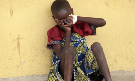 A girl rescued from Boko Haram militants hides her face at the Malkohi camp for internally displaced persons outside Yola, north-east Nigeria.