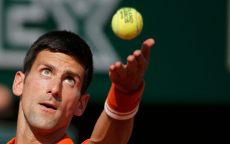 Novak Djokovic serves.