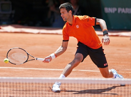 Novak Djokovic returns the ball to Andy Murray with the semi-final back under way.