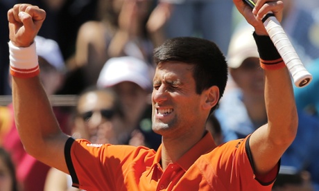 Novak Djokovic raises his arms after defeating Andy Murray.