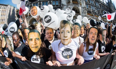 Anti-poverty activists wear masks of the G7 leaders in Munich on Saturday.