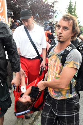An injured protester is carried away in Garmisch-Partenkirchen after scuffles between activists and riot police.