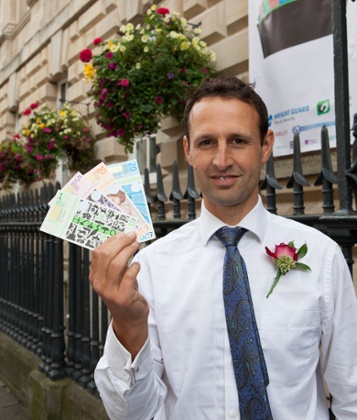 Ciaran Mundy with some denominations of the Bristol pound.