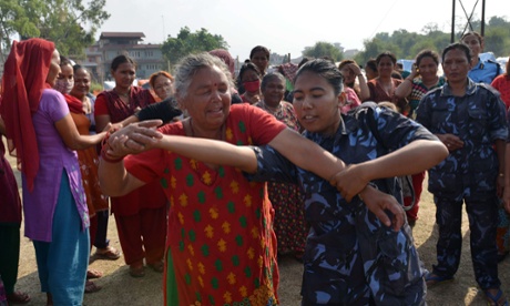Nepalese police officers conduct a self defence training session for women and children at a shelter for earthquake victims in Kathmandu.
