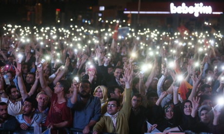 Supporters wave Turkish flags and shout slogans outside the AK Party headquarters.