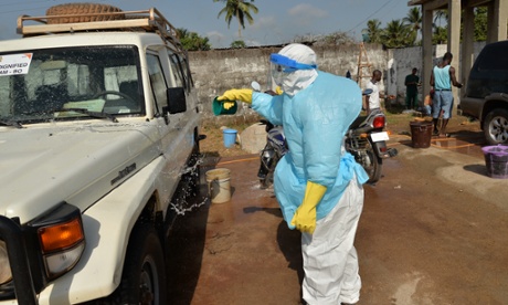 Maseray disinfects the ambulance after a burial in Sierra Leone.