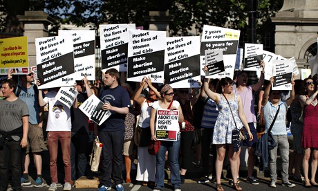 Pro-choice supporters hold placards in front of the Irish parliament building in Dublin 