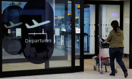 Woman walking through departures at an airport