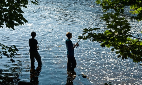 Two boy anglers fishing in a river.