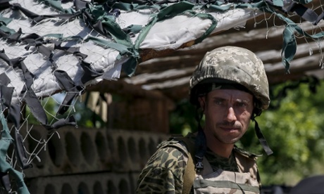 A Ukrainian serviceman a checkpoint at the frontline with pro-Russian separatists in Novotoshkivske, eastern Ukraine on 8 June.