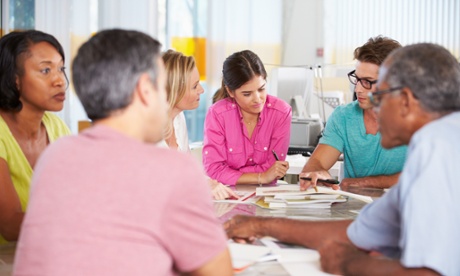 Team of workers comparing notes