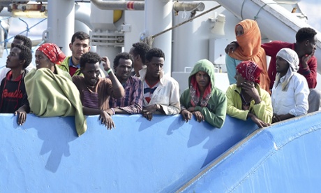 Rescued migrants stand on a deck of the Swedish Coast Guard ship KBV 001 Poseidon prior to arriving in Italy