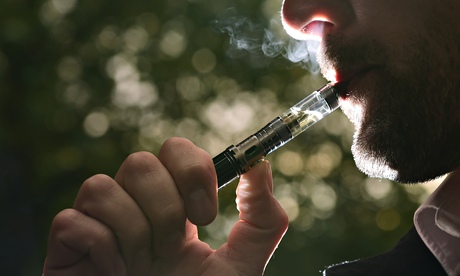 A man smokes an electronic cigarette