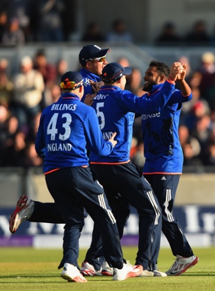 Adil Rashid of England celebrates with team-mates after Williamson's wicket.