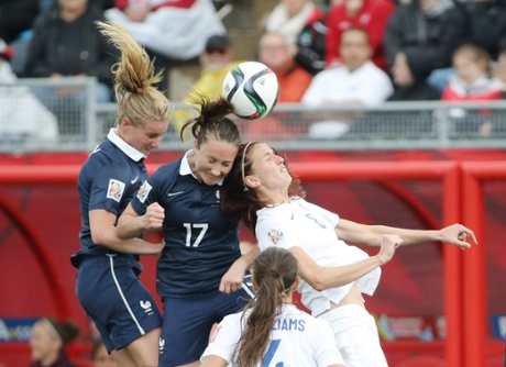 England midfielder Jill Scott goes up for a header against France midfielder Amandine Henry, left, and  Gaetane Thiney.