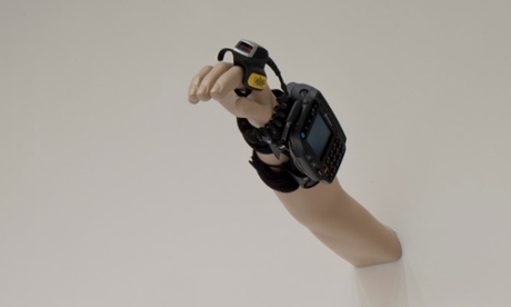 A tracking device like those that workers in warehouses have to wear to monitor their output.