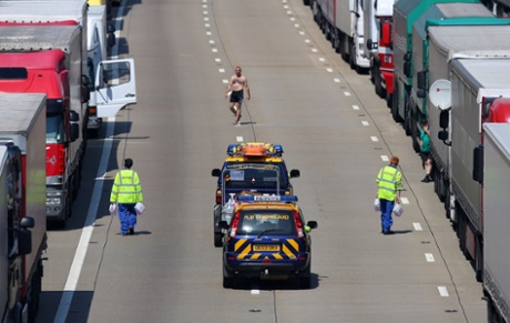 Members of the Coastguard hand out water to stranded lorry drivers on the M20 in Ashford