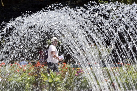 A man walks by a fountain of the Jardin des Plantes in Toulouse.