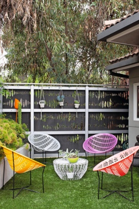 The tiny front garden is filled with planters.