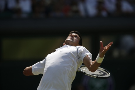 The defending champion gets ready to fire a serve to his opponent.