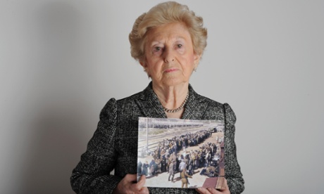 Irene Weiss holds a photo of her.