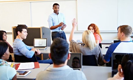 Male Tutor Teaching University Students In Classroom