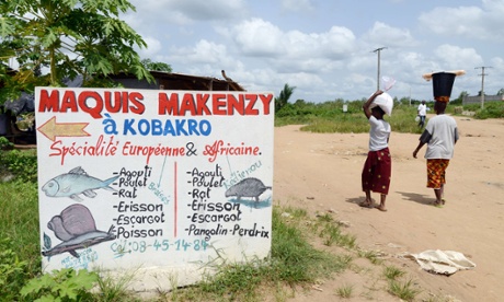 People walk past the sign of a 