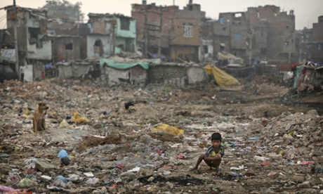 MDG7 has achieved some success is ending scenes like this, where a boy defecates in the open on wasteground in front of slums in New Delhi.