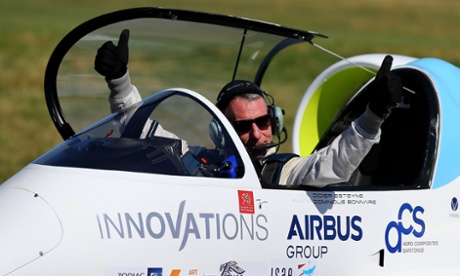 Pilot Didier Esteyne celebrates after landing the E-Fan electrically powered plane following his successful crossing of The Channel from Lydd Airport in Kent.