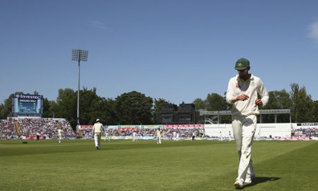 Nathan Lyon of Australia collects the ball from the rope after Joe Root of England hit a boundary.