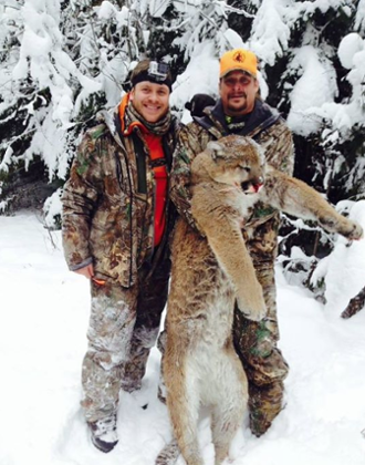 Kid Rock (right) with a cougar carcass.