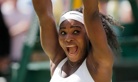 Serena Williams raises the winner’s trophy.