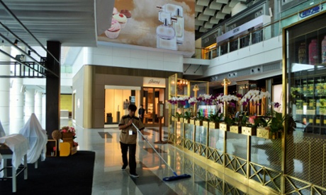 Cleaning staff mop spotless floors in the deadly quiet skyscraper.