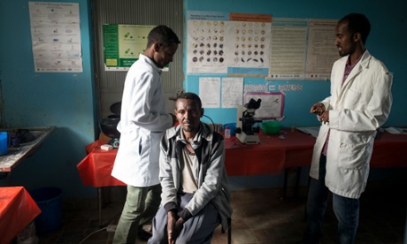 A man with suspected malaria waits to be tested by lab technicians in Derberk, Ethiopia in May 2015.