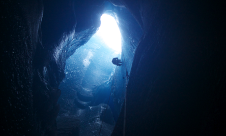 Abseiling into a moulin on the Greenland ice sheet.