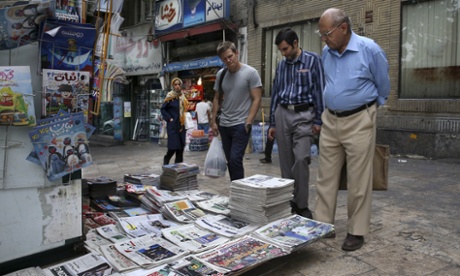 People read the front pages of Iranian newspapers at a newsstand in Tajrish Square, northern Tehran, Iran.